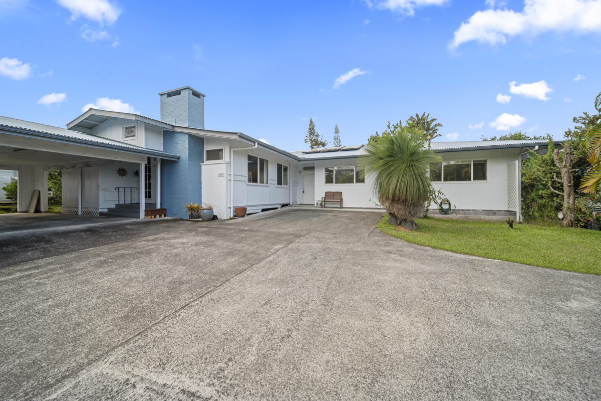 1808 Waianuenue Avenue Hilo, HI 96720 - Photo 1 of 30 a view of a house with a yard and palm trees