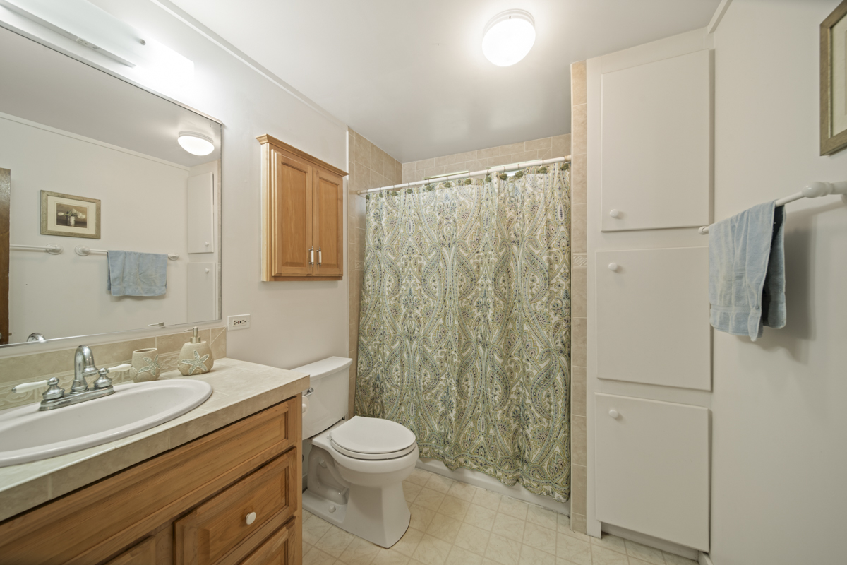 1808 Waianuenue Avenue Hilo, HI 96720 - Photo 11 of 30 a bathroom with a granite countertop sink toilet and shower