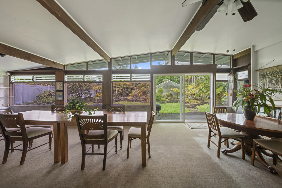 1808 Waianuenue Avenue Hilo, HI 96720 - Photo 15 of 30 a dining room with furniture water view and a floor to ceiling window