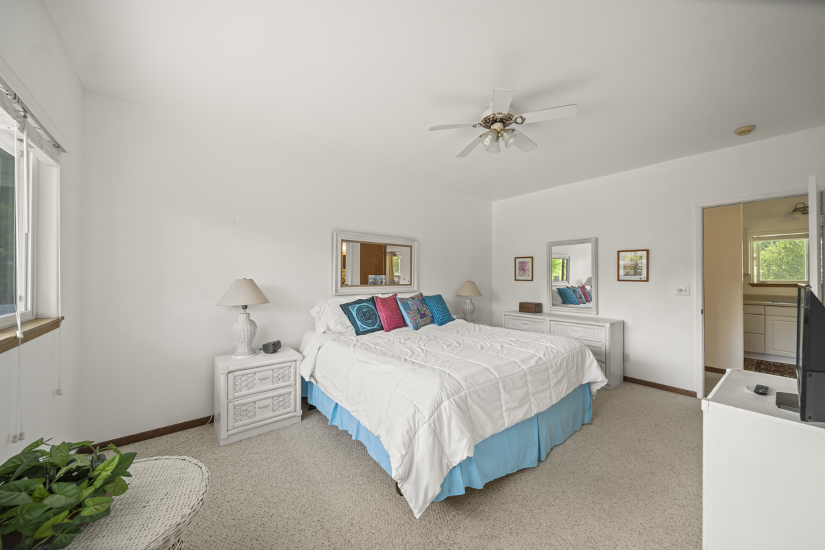 1808 Waianuenue Avenue Hilo, HI 96720 - Photo 19 of 30 a bedroom with a bed and a flat screen tv