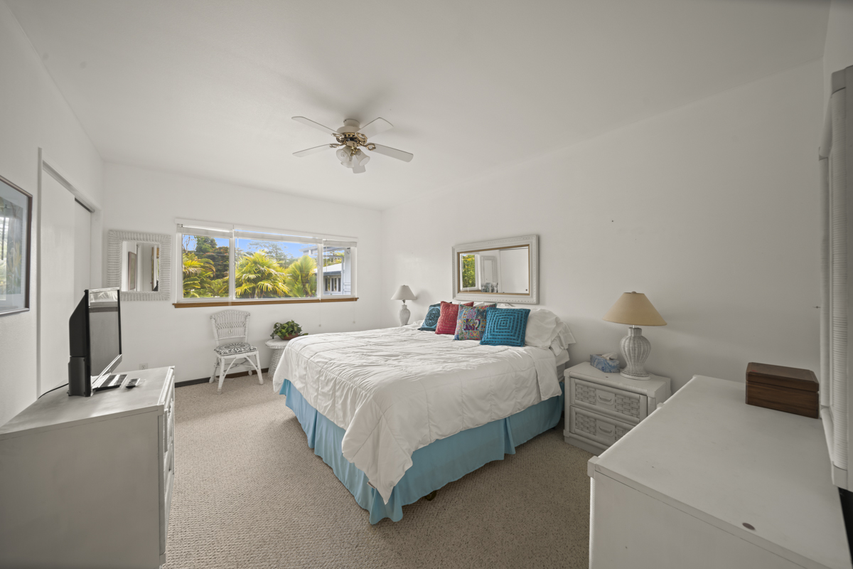 1808 Waianuenue Avenue Hilo, HI 96720 - Photo 20 of 30 a bedroom with a bed and wooden floor