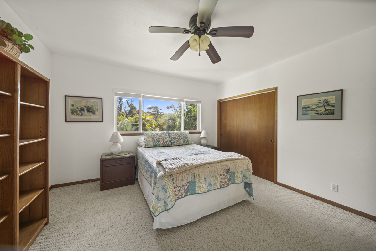 1808 Waianuenue Avenue Hilo, HI 96720 - Photo 22 of 30 a bedroom with a bed and a chandelier