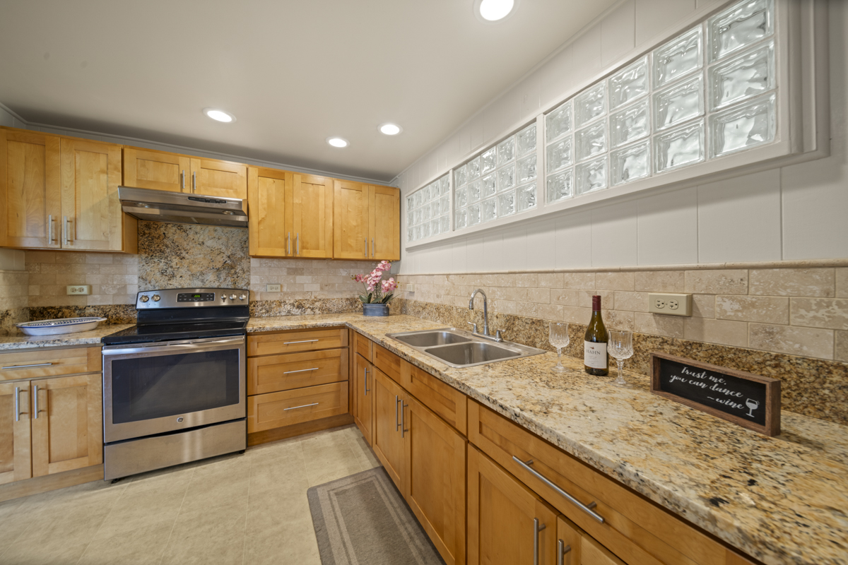 1808 Waianuenue Avenue Hilo, HI 96720 - Photo 5 of 30 a kitchen with a sink stove and cabinets