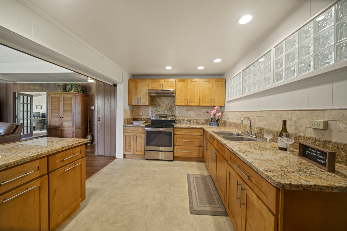 1808 Waianuenue Avenue Hilo, HI 96720 - Photo 6 of 30 a kitchen with stainless steel appliances granite countertop sink stove refrigerator and cabinets