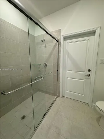 a bathroom with a shower and a toilet