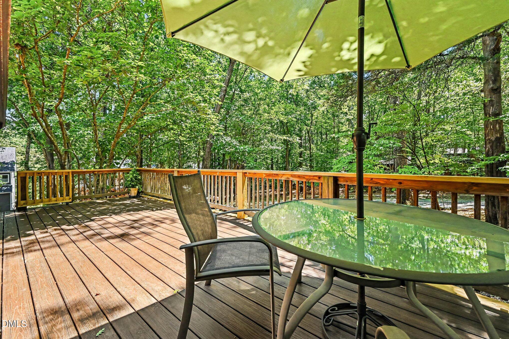 200 Spring Valley Road Carrboro, NC 27510 - Photo 23 of 38 a view of a chairs and table on the wooden deck