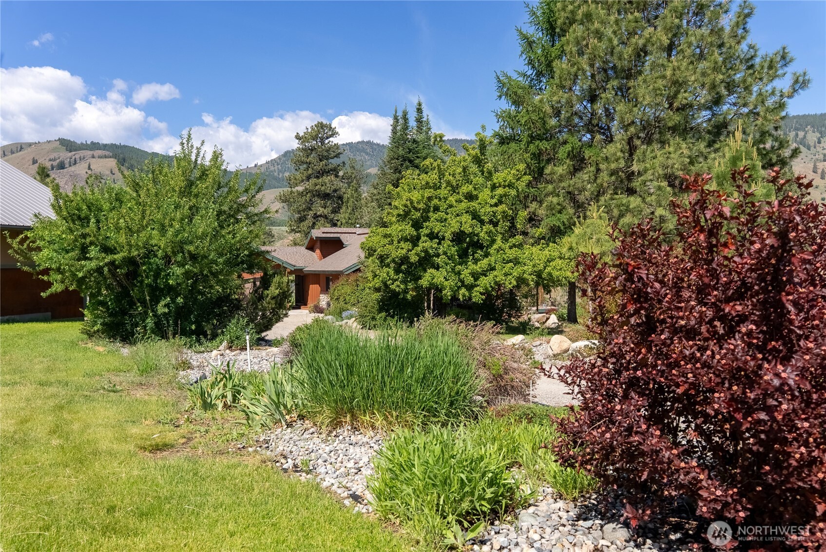 2621 Highway 153 Twisp, WA 98856 - Photo 39 of 40 a view of a garden with large trees