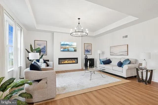 a living room with furniture and a chandelier