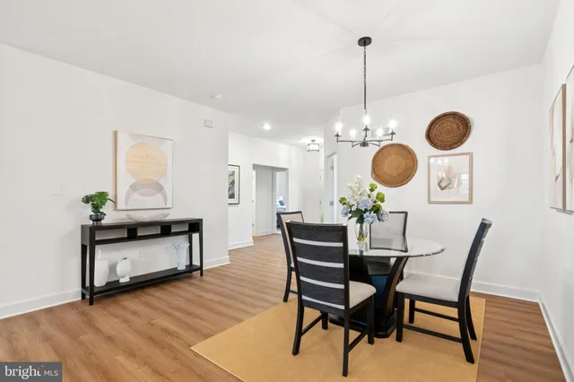 a kitchen with stainless steel appliances granite countertop white cabinets and a stove a refrigerator with white cabinets