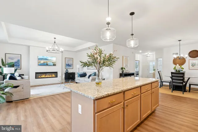 a kitchen with granite countertop white cabinets and a sink
