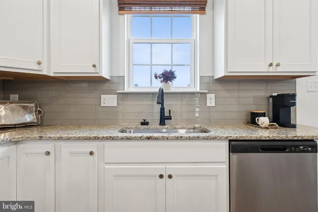 a bedroom with a bed and painting on the wall