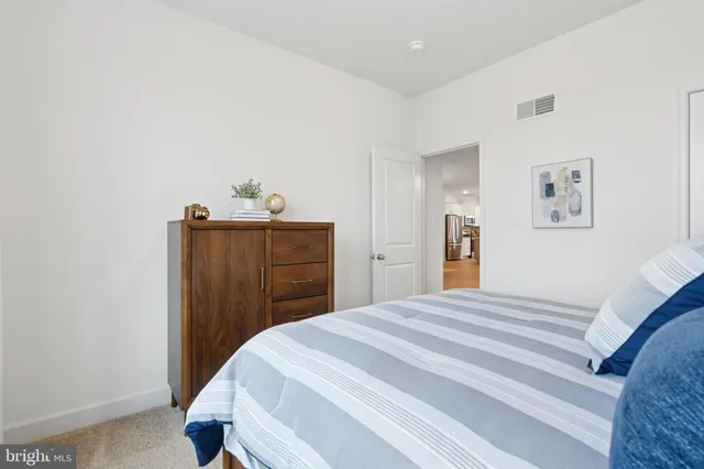 a bedroom with a bed a lamp and a window