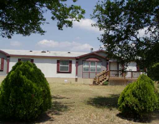 8015 Burleson Manor Road Manor, TX 78653 - Photo 1 of 1 a view of a house with a yard and tree s