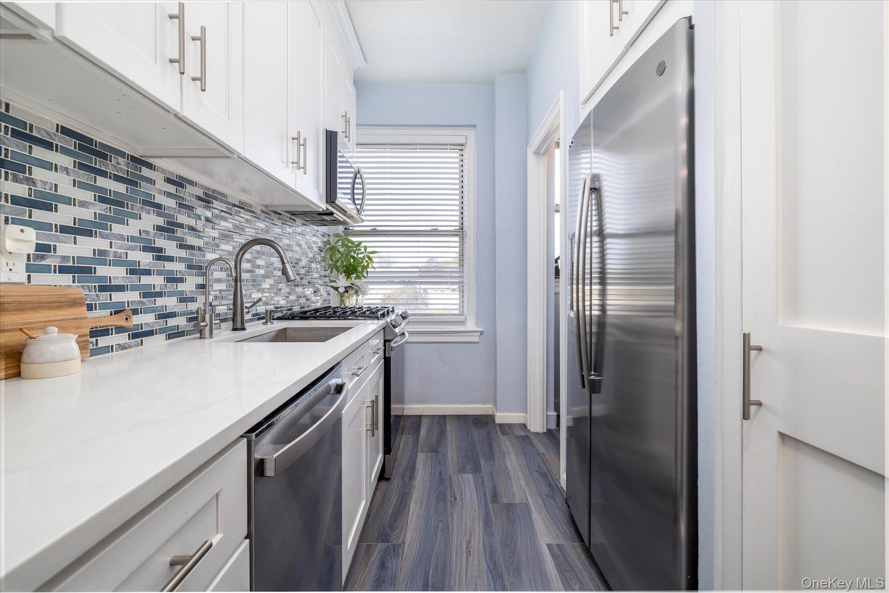 8 Barstow Road, Unit 4J Great Neck, NY 11021 - Photo 1 of 17 a kitchen with a sink and refrigerator