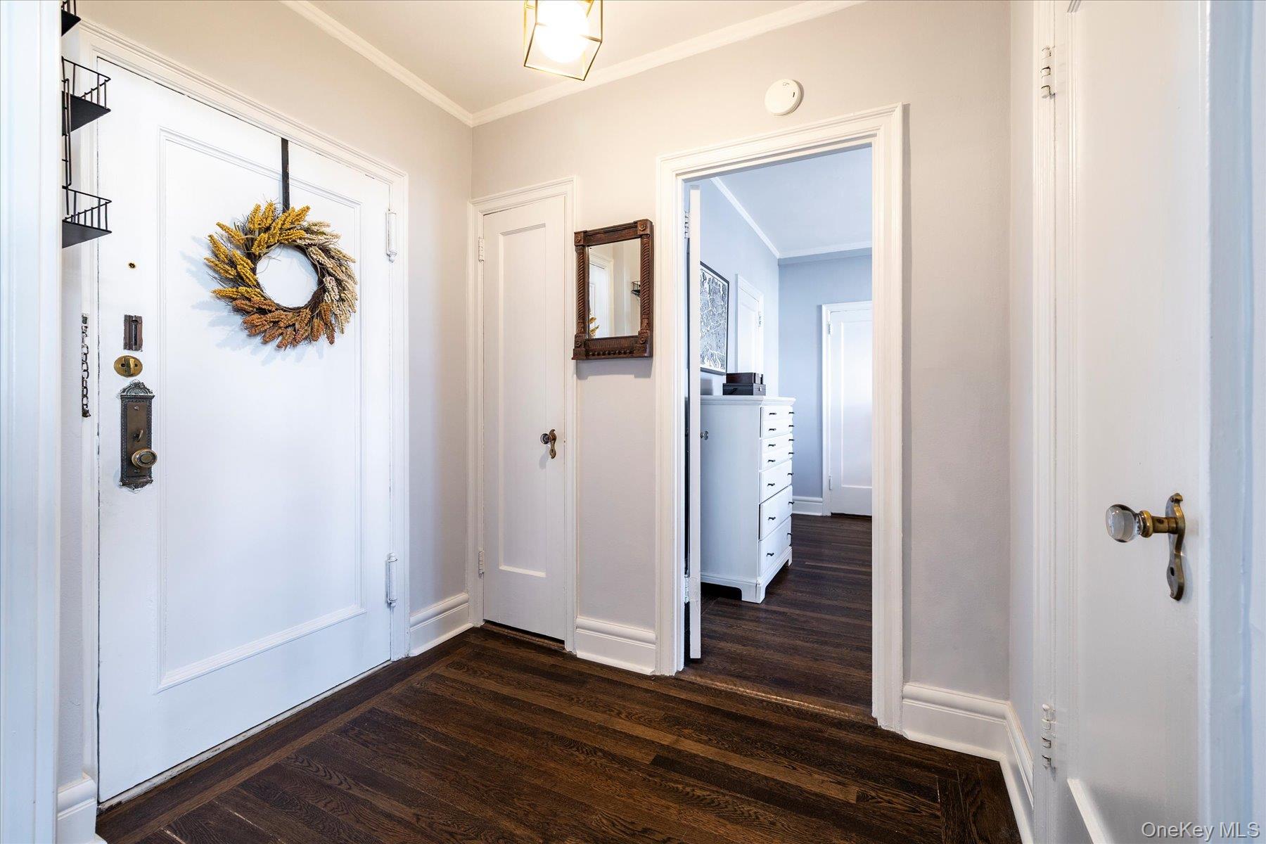 8 Barstow Road, Unit 4J Great Neck, NY 11021 - Photo 11 of 17 a view of a hallway with wooden floor and staircase