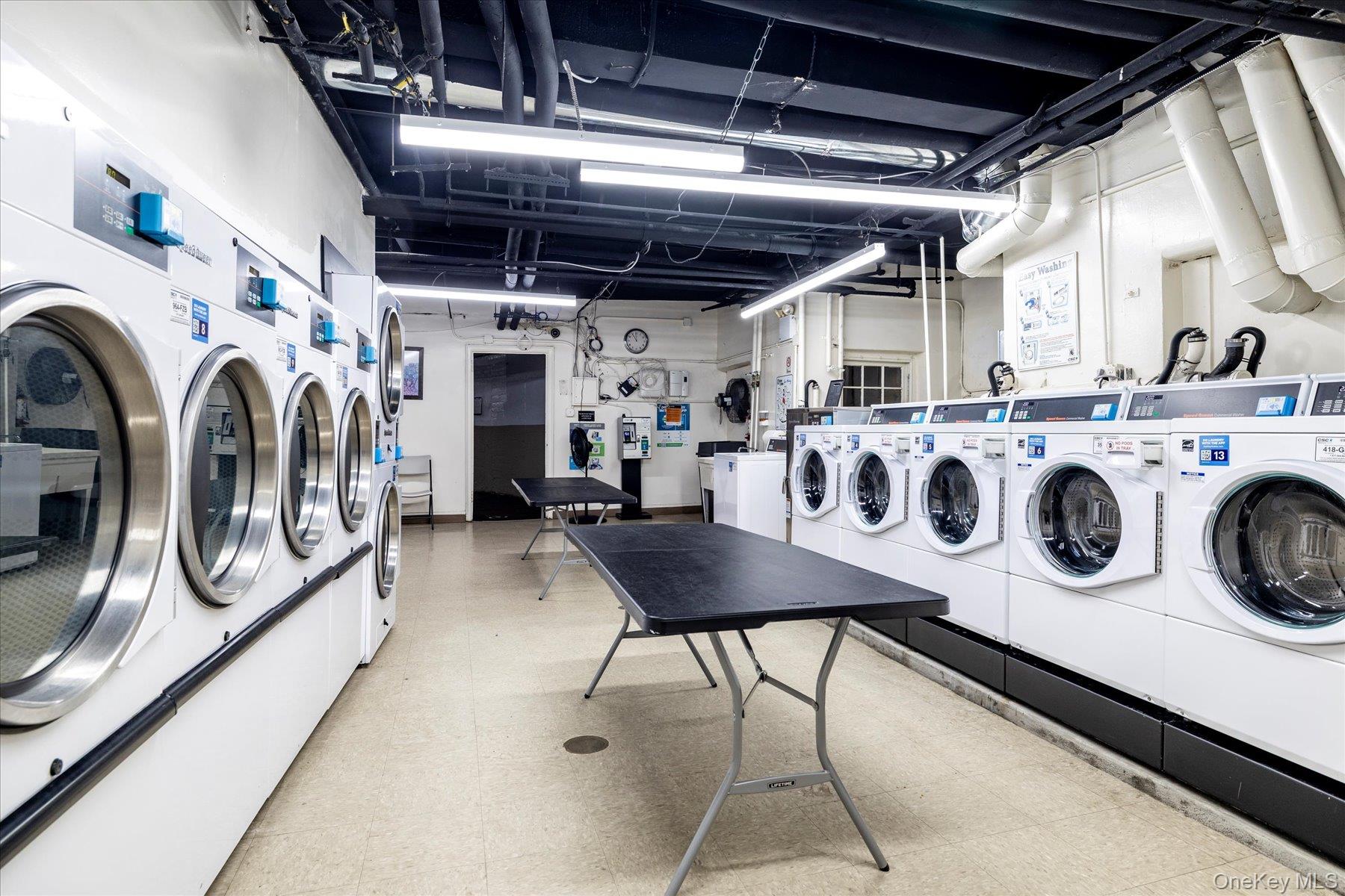 8 Barstow Road, Unit 4J Great Neck, NY 11021 - Photo 14 of 17 a utility room with dryer and washer