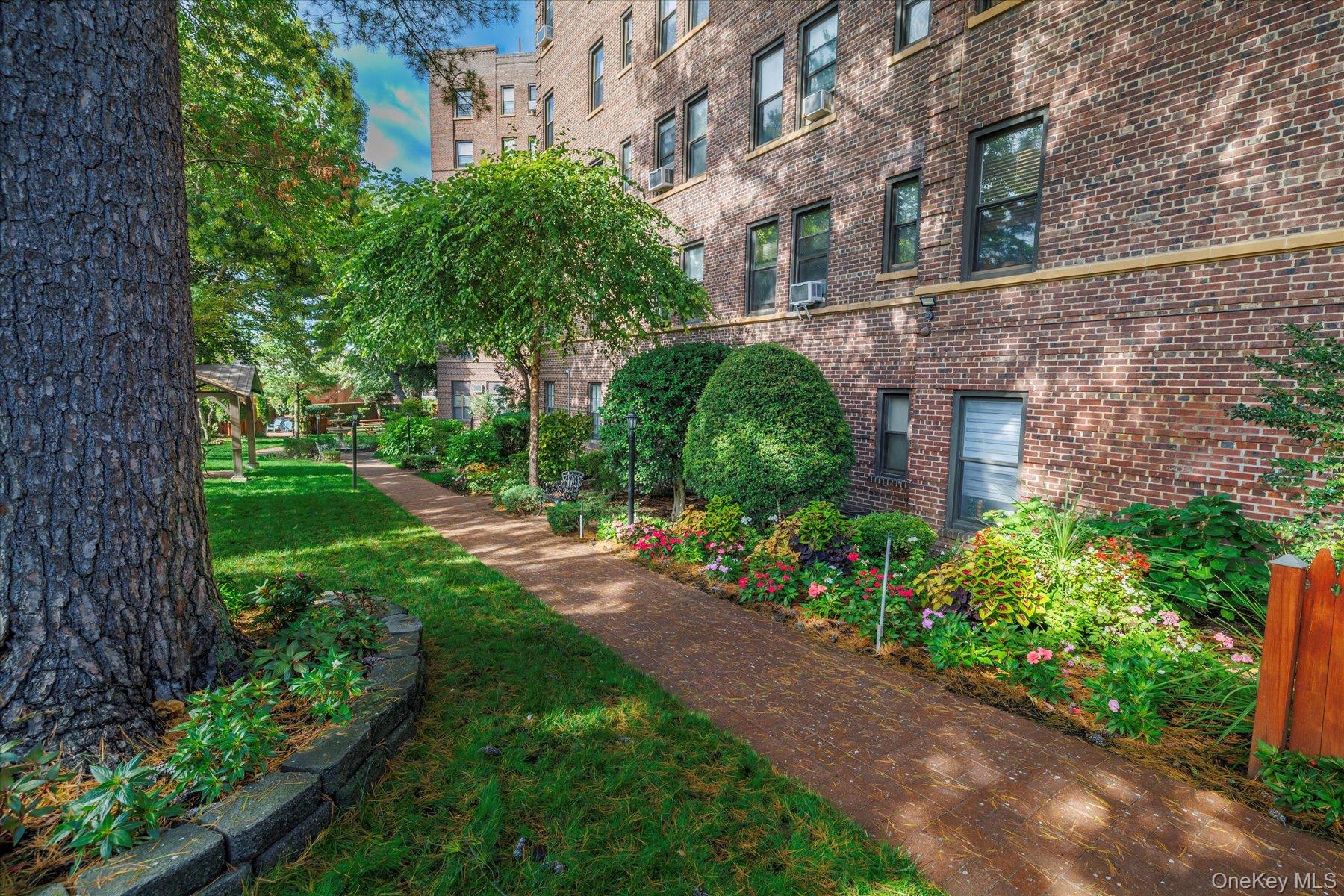 8 Barstow Road, Unit 4J Great Neck, NY 11021 - Photo 15 of 17 a view of a building with a garden