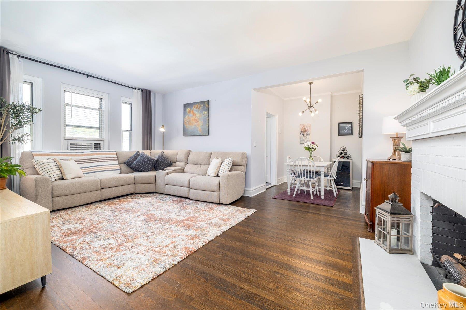 8 Barstow Road, Unit 4J Great Neck, NY 11021 - Photo 5 of 17 a living room with furniture and a fireplace