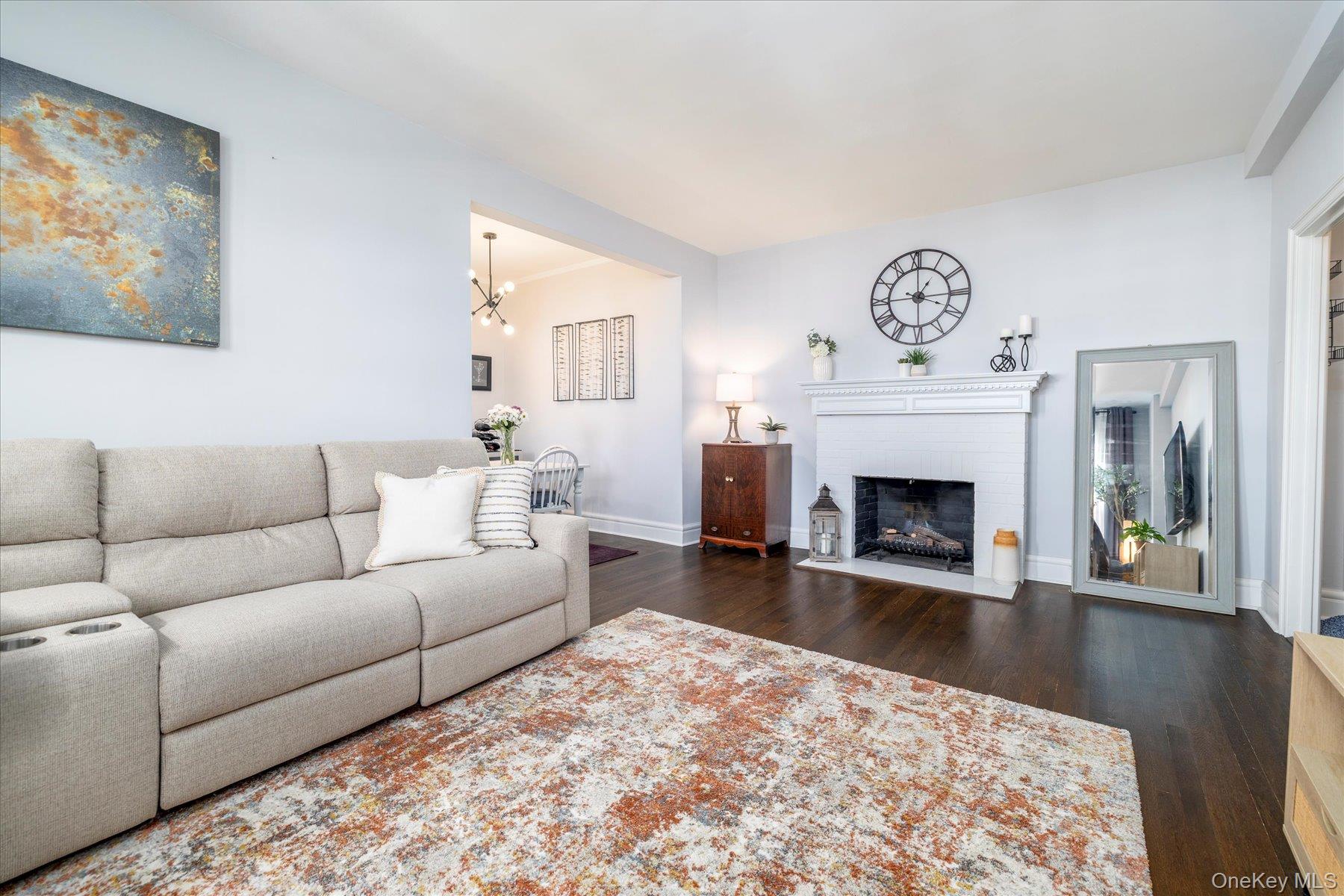 8 Barstow Road, Unit 4J Great Neck, NY 11021 - Photo 6 of 17 a living room with furniture and a fireplace