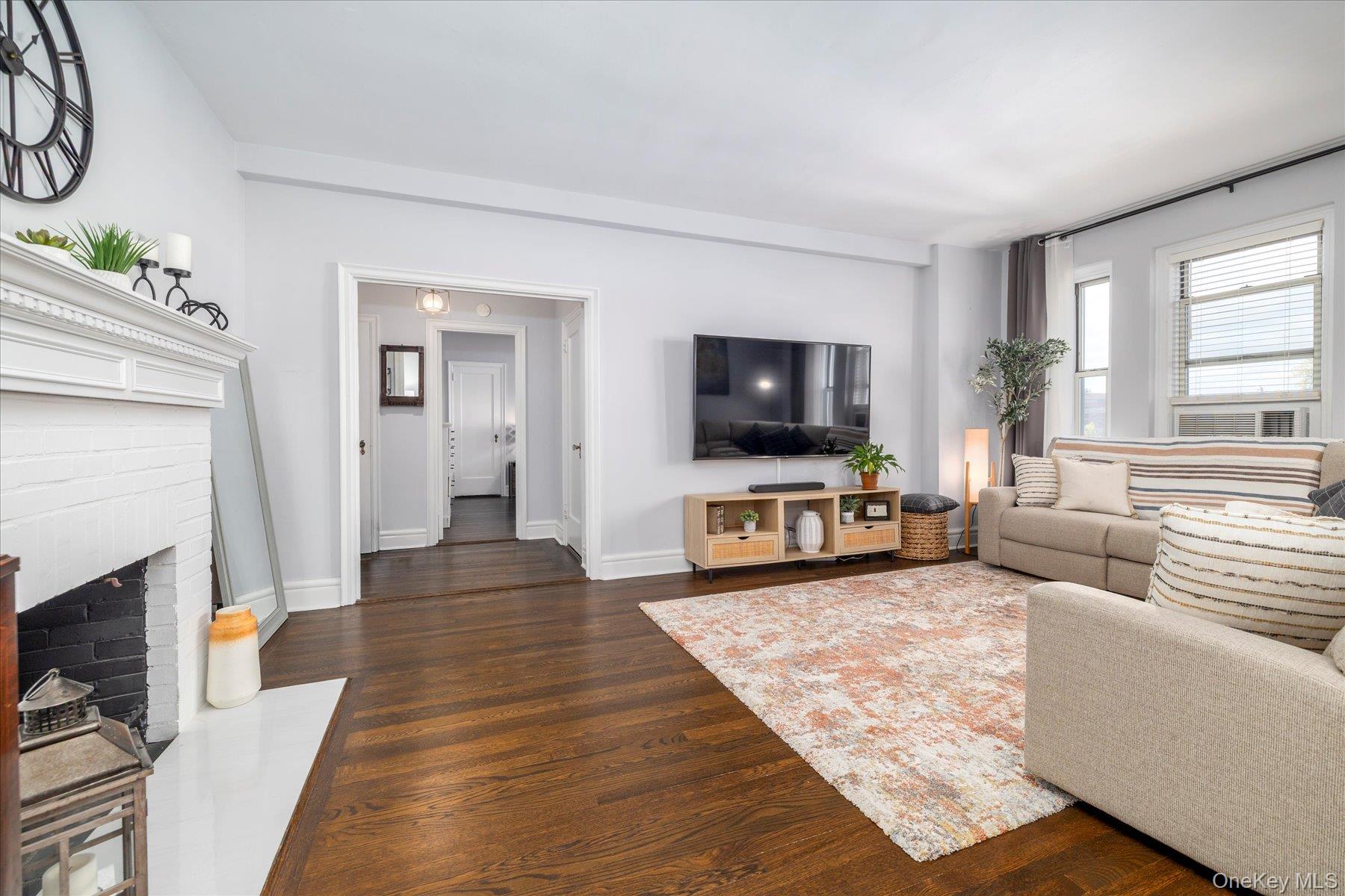 8 Barstow Road, Unit 4J Great Neck, NY 11021 - Photo 7 of 17 a living room with furniture and a flat screen tv