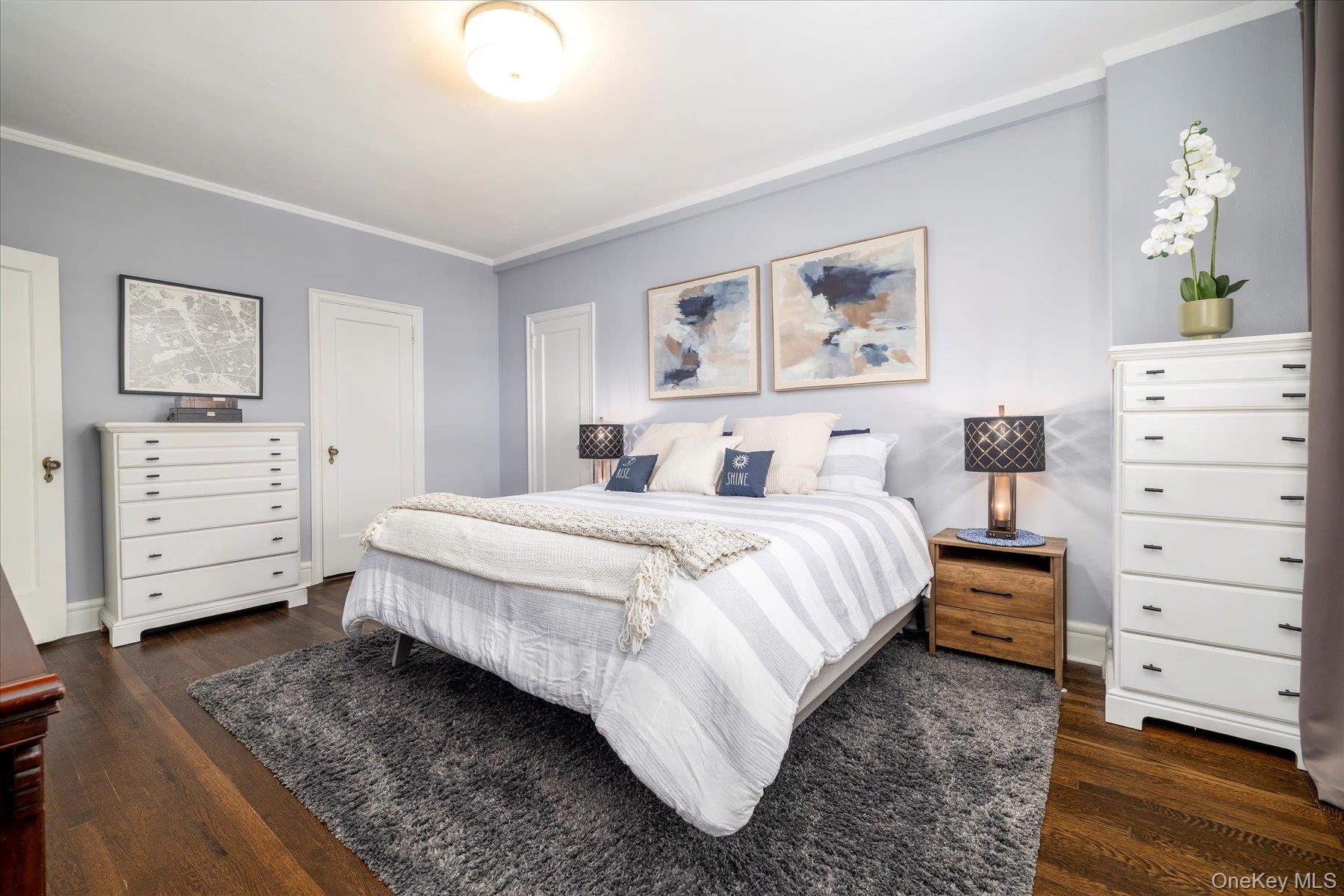 8 Barstow Road, Unit 4J Great Neck, NY 11021 - Photo 9 of 17 a bedroom with a bed and a dresser