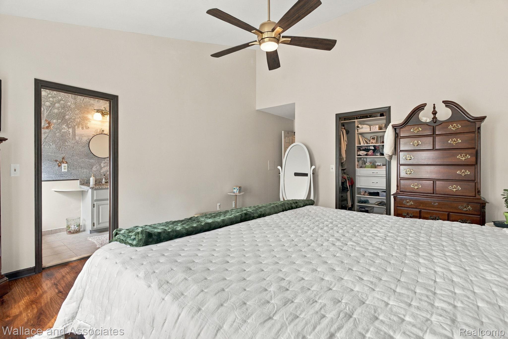 17076 27 Mile Road Ray, MI 48096 - Photo 24 of 63 Vaulted ceiling with a ceiling fan, wood-finish flooring, and a built-in closet system
