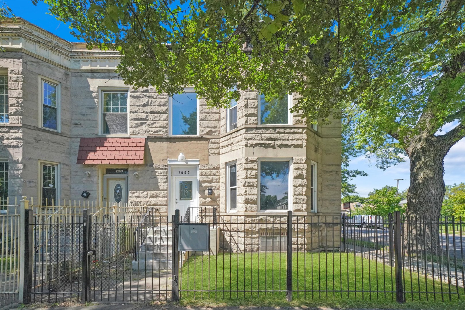 6600 South Marquette Road Chicago, IL 60637 - Photo 1 of 42 a front view of a house with a garden
