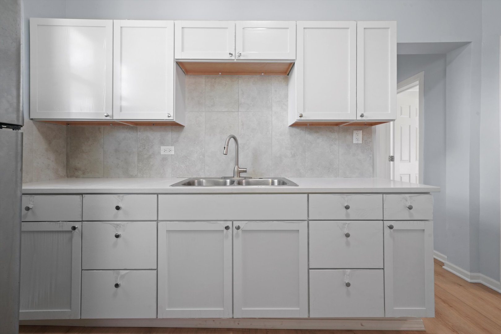 6600 South Marquette Road Chicago, IL 60637 - Photo 3 of 42 a kitchen with white cabinets and a sink