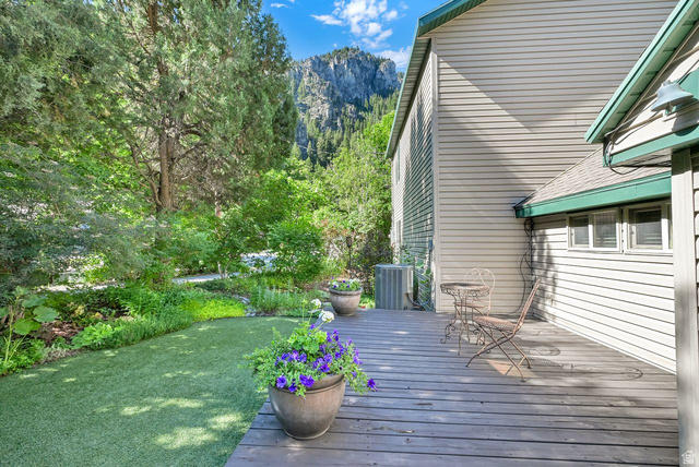 655 Ogden Canyon Road Ogden, UT 84401 - Photo 6 of 50 Expansive wooden deck with a built-in outdoor light fixture, siding exterior, and a manicured artificial turf lawn