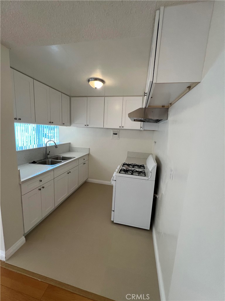 366 North Vecino Drive, Unit 1 Covina, CA 91723 - Photo 4 of 8 a kitchen with kitchen island a sink a stove and a refrigerator