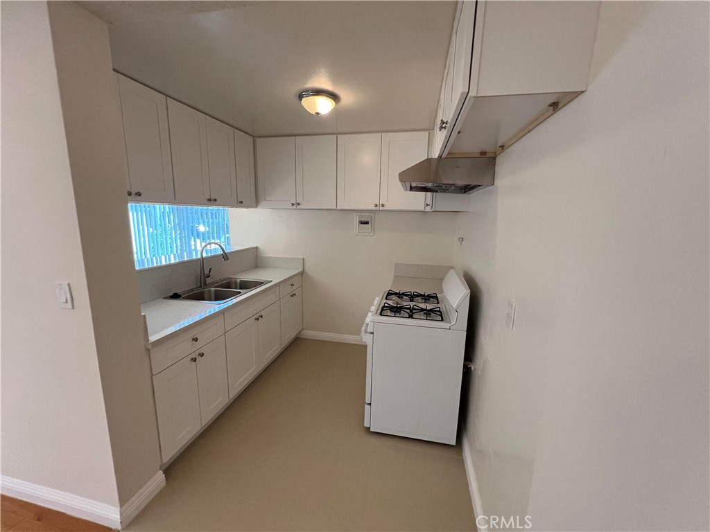 366 North Vecino Drive, Unit 1 Covina, CA 91723 - Photo 5 of 8 a kitchen with stainless steel appliances granite countertop a sink a stove a refrigerator and cabinets