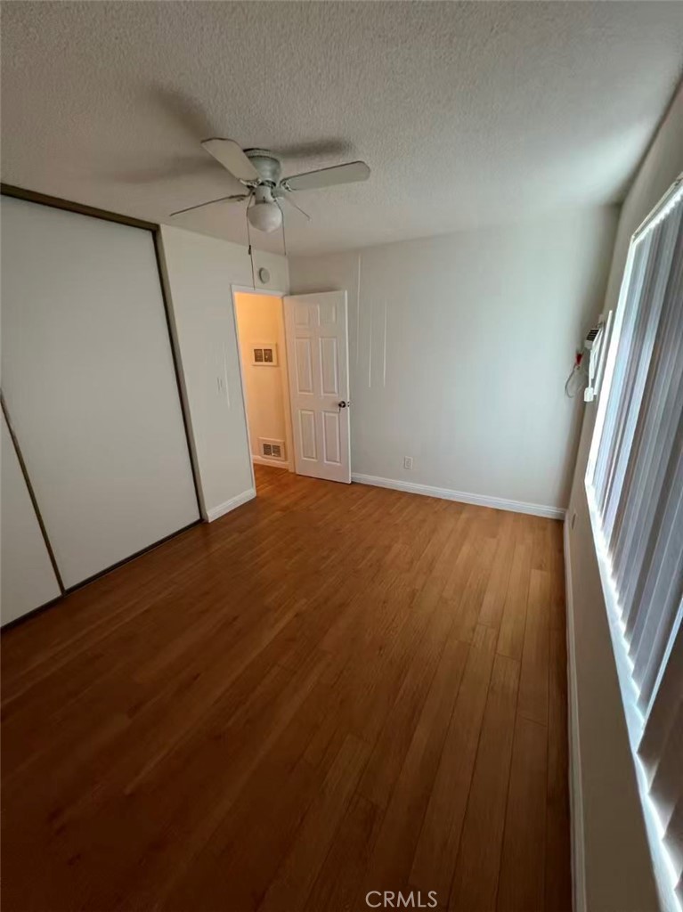 366 North Vecino Drive, Unit 1 Covina, CA 91723 - Photo 6 of 8 en empty room with wooden floor and windows