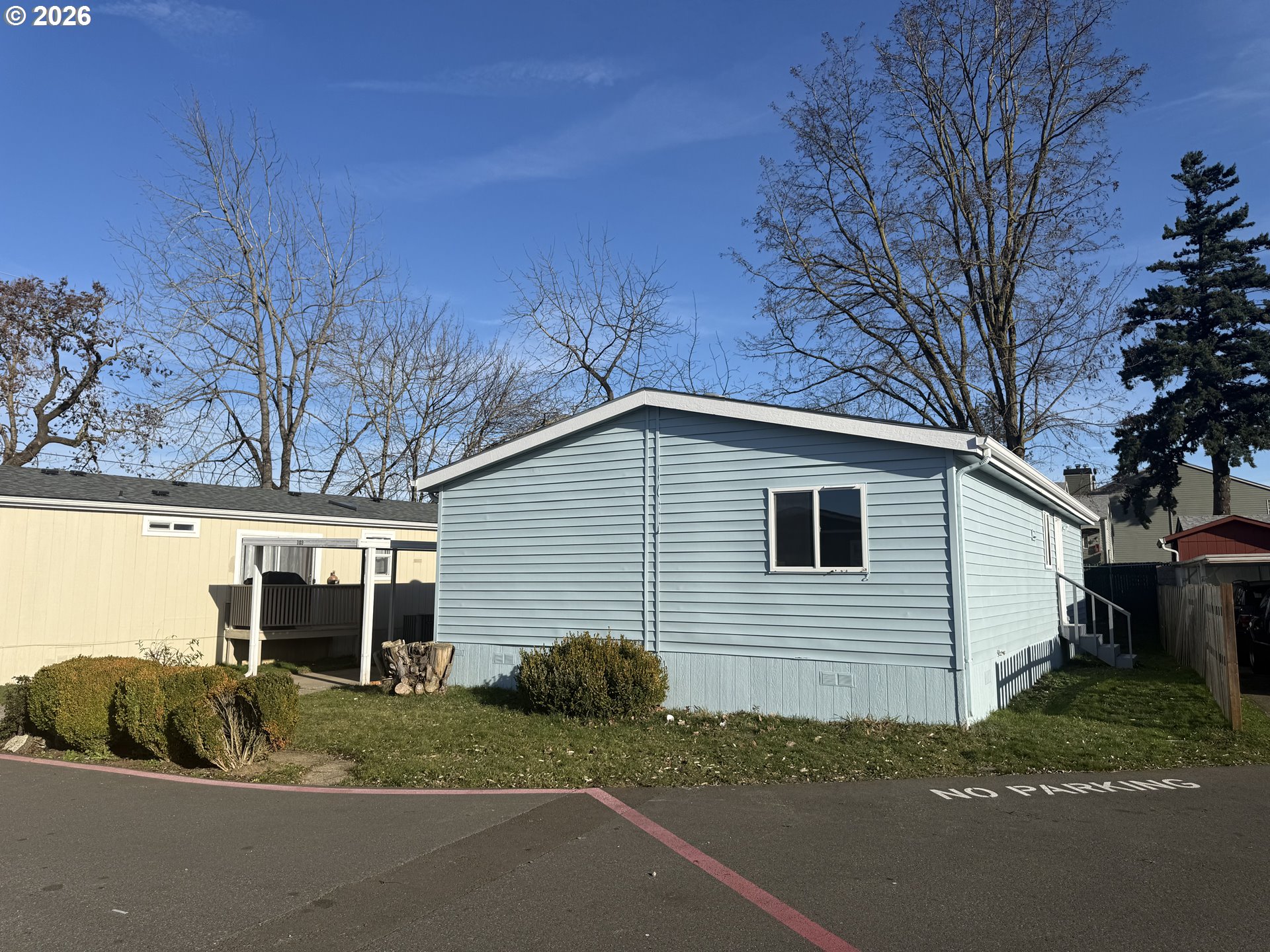 20140 Northeast Sandy Boulevard, Unit 103 Fairview, OR 97024 - Photo 2 of 15 a front view of a house with a yard and garage