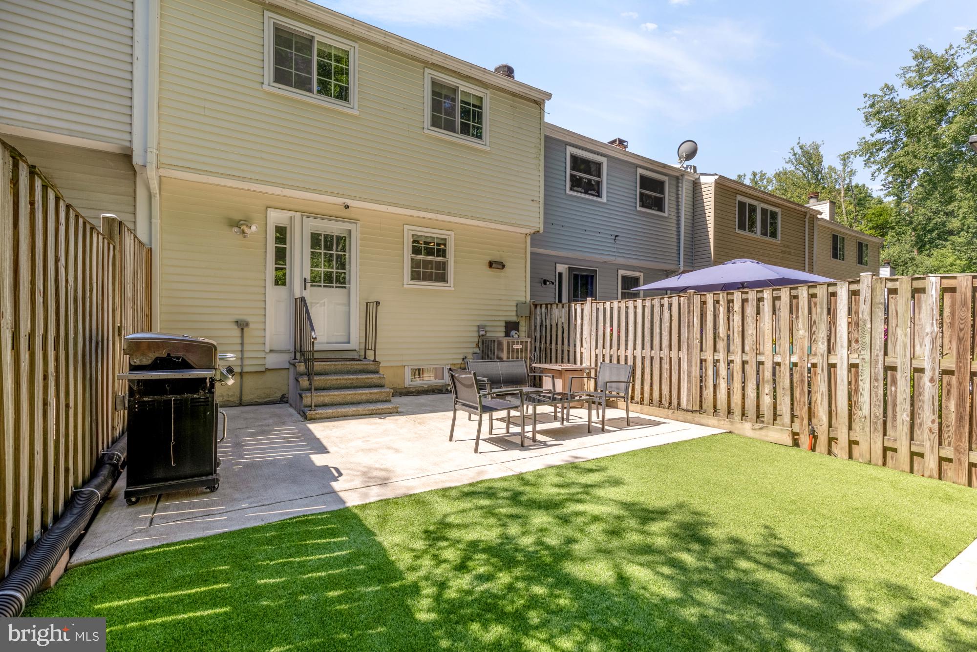 8100 Loving Forest Court Springfield, VA 22153 - Photo 32 of 33 a view of a patio with table and chairs and wooden fence