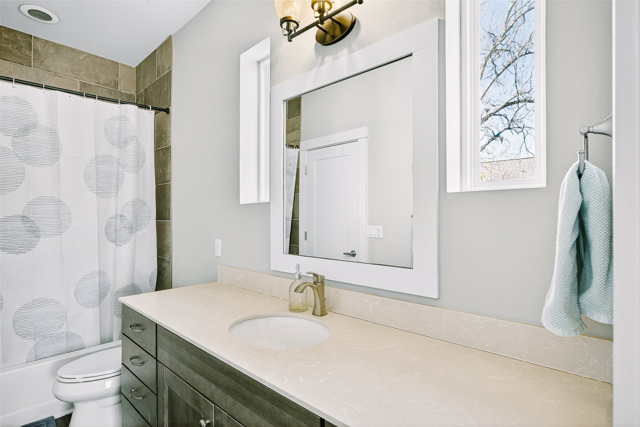 4917 Sunset Trail, Unit A Austin, TX 78745 - Photo 25 of 35 Bathroom featuring vanity and shower / tub combo with curtain