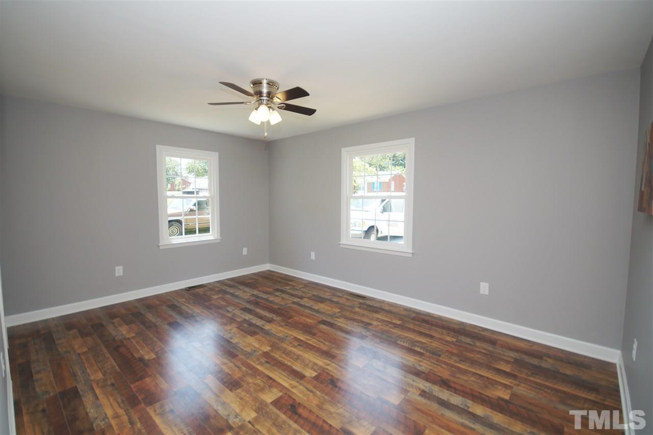2717 Knowles Street Raleigh, NC 27603 - Photo 14 of 26 a view of empty room with wooden floor and fan