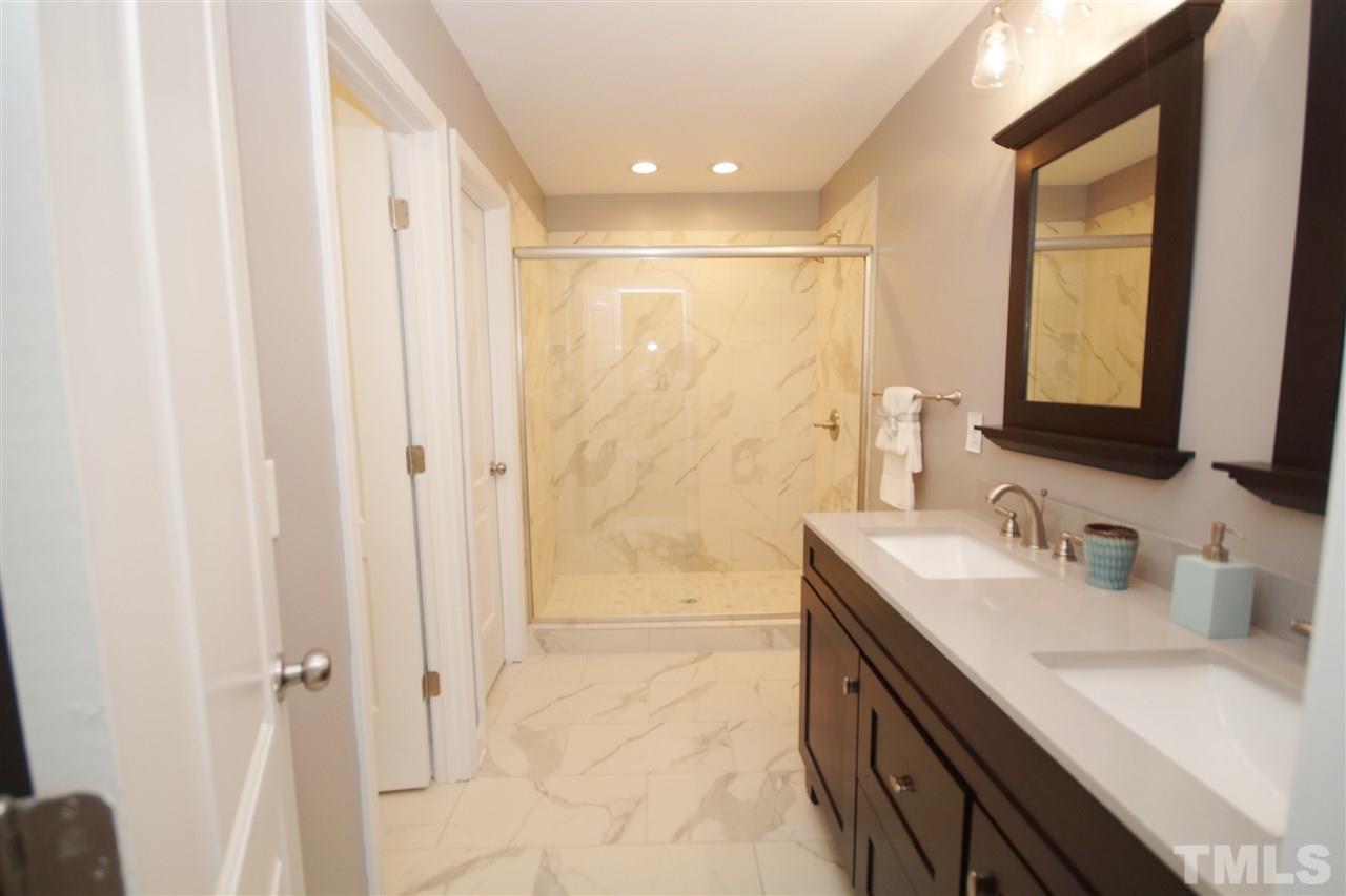 2717 Knowles Street Raleigh, NC 27603 - Photo 17 of 26 a bathroom with a double vanity sink mirror and