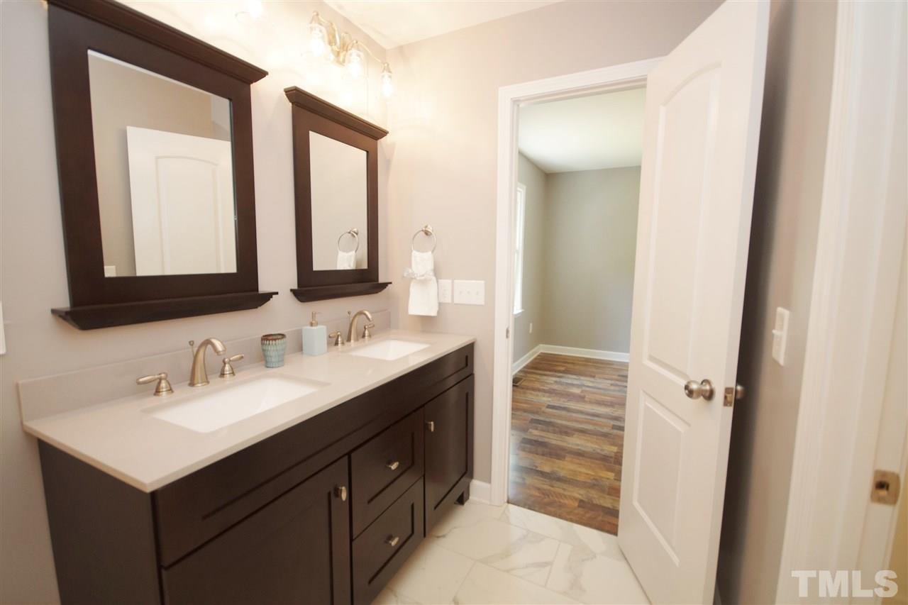 2717 Knowles Street Raleigh, NC 27603 - Photo 19 of 26 a bathroom with a sink vanity and mirror