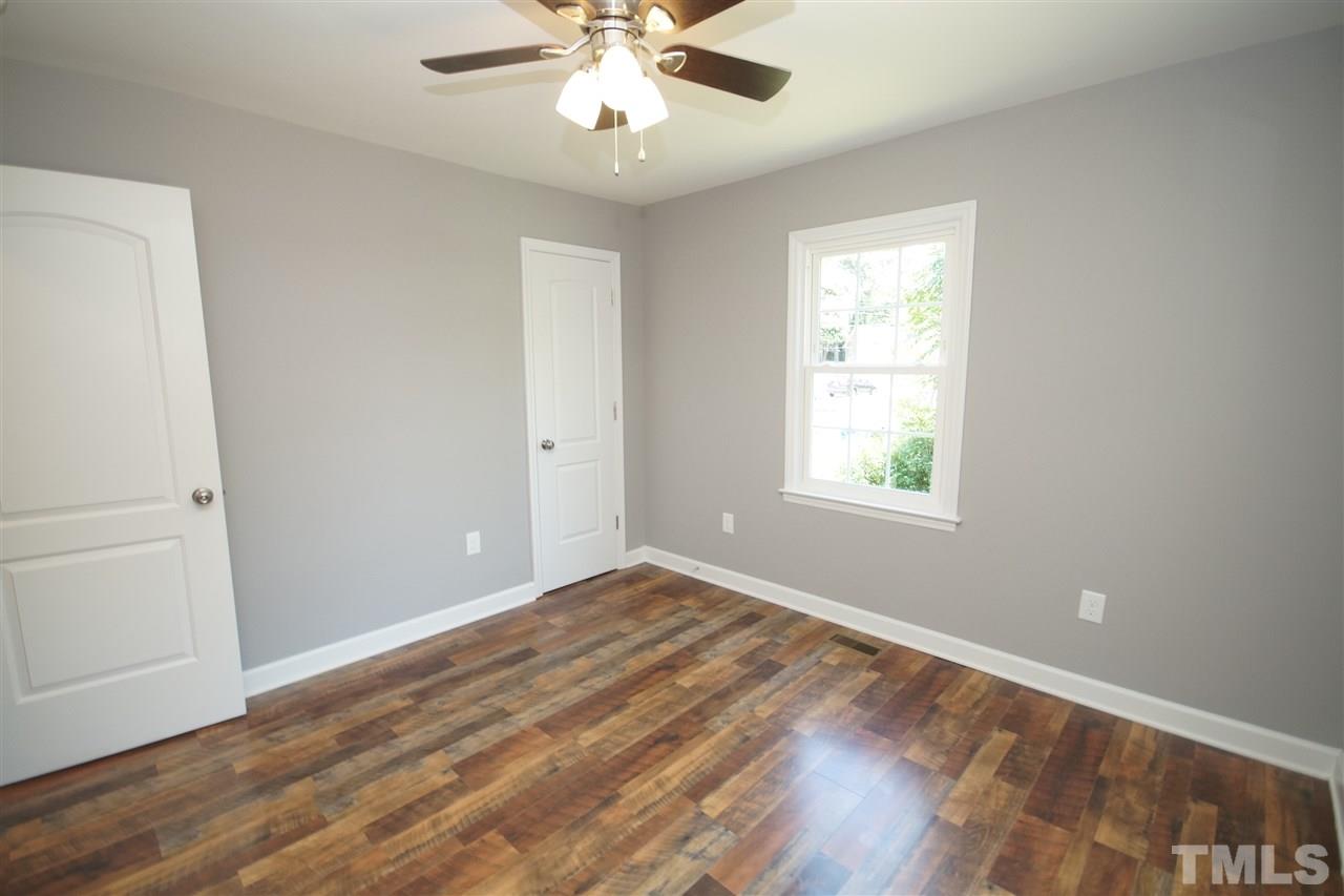 2717 Knowles Street Raleigh, NC 27603 - Photo 22 of 26 a view of an empty room with wooden floor and a window