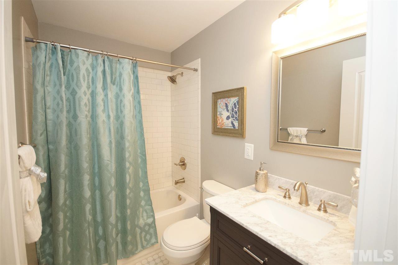 2717 Knowles Street Raleigh, NC 27603 - Photo 23 of 26 a bathroom with a granite countertop sink toilet and shower