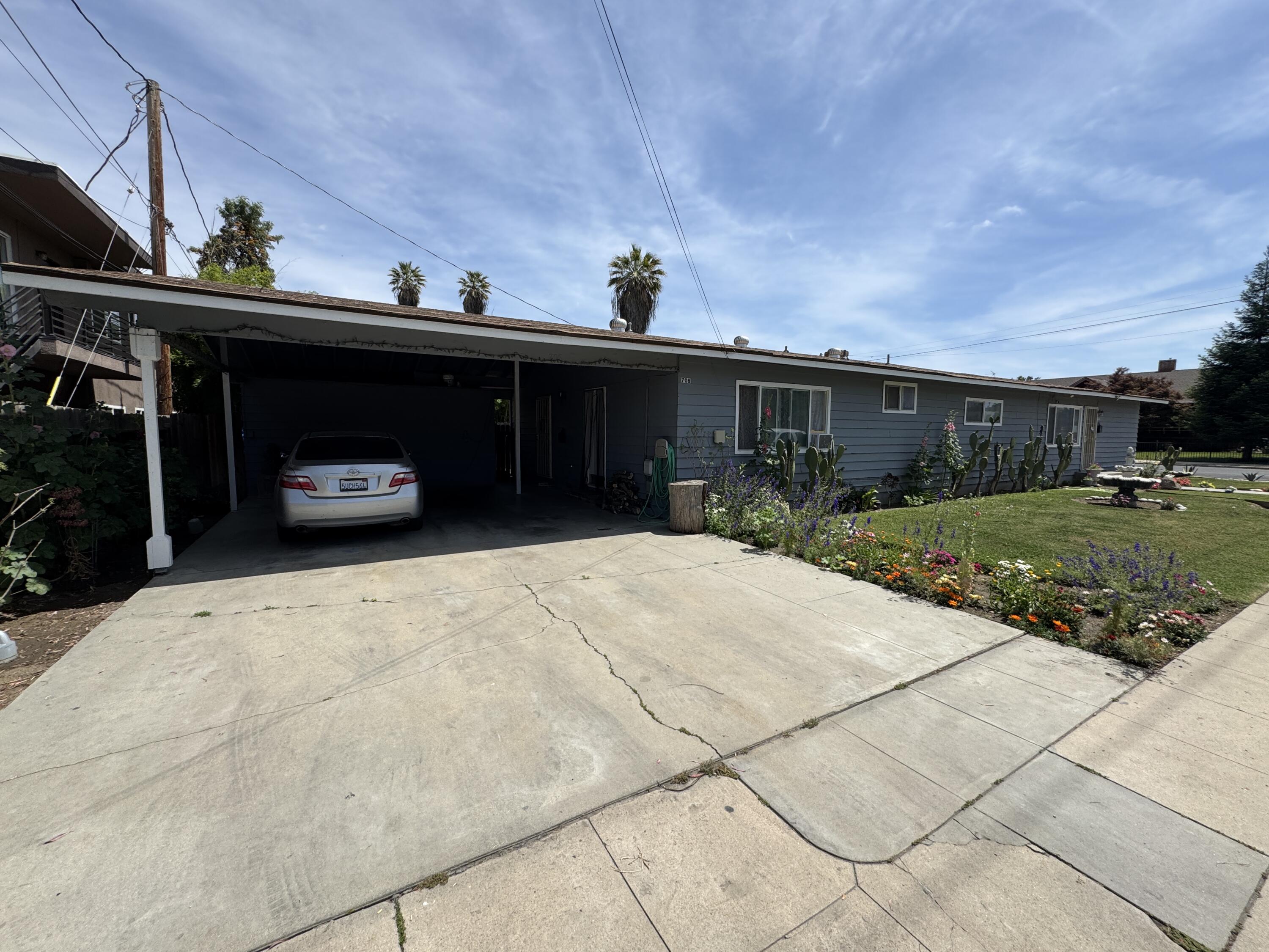 704 North Floral Street Visalia, CA 93291 - Photo 6 of 51 a front view of a house with a yard