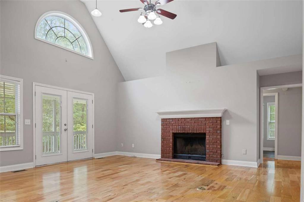 9375 Brian Boulevard Winston, GA 30187 - Photo 11 of 70 wooden floor fireplace and windows in an empty room