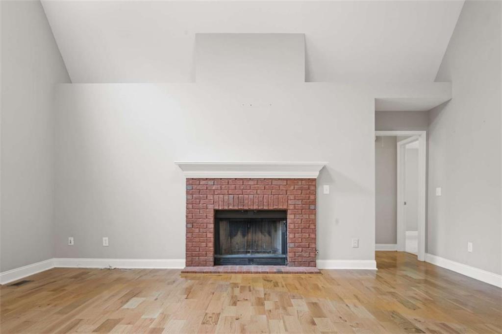 9375 Brian Boulevard Winston, GA 30187 - Photo 12 of 70 a view of an empty room with wooden floor and a fireplace