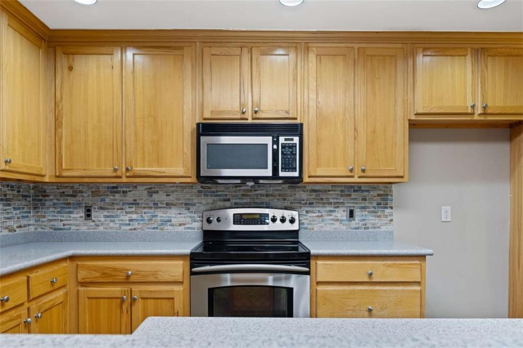 9375 Brian Boulevard Winston, GA 30187 - Photo 18 of 70 a kitchen with granite countertop wood cabinets stainless steel appliances and sink