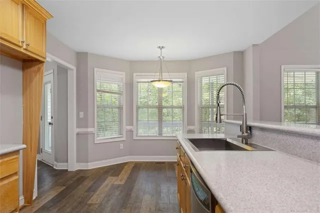 a view of a kitchen with a sink dishwasher and fireplace