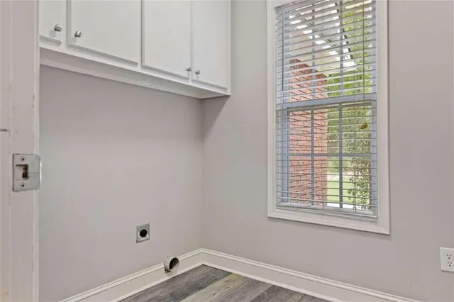 a bathroom with a sink a toilet and a window