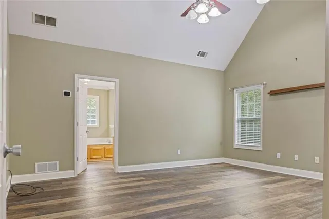 a kitchen with stainless steel appliances cabinets and a wooden floor