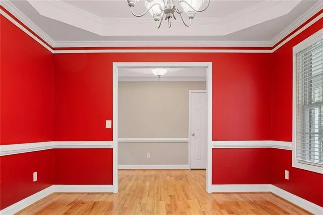 a dining room with furniture a chandelier and window