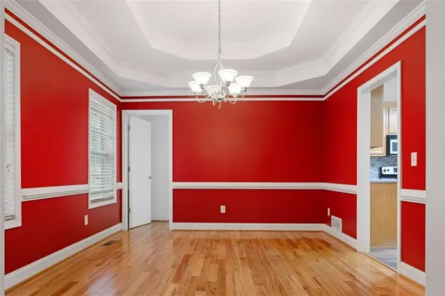 wooden floor fireplace and windows in an empty room