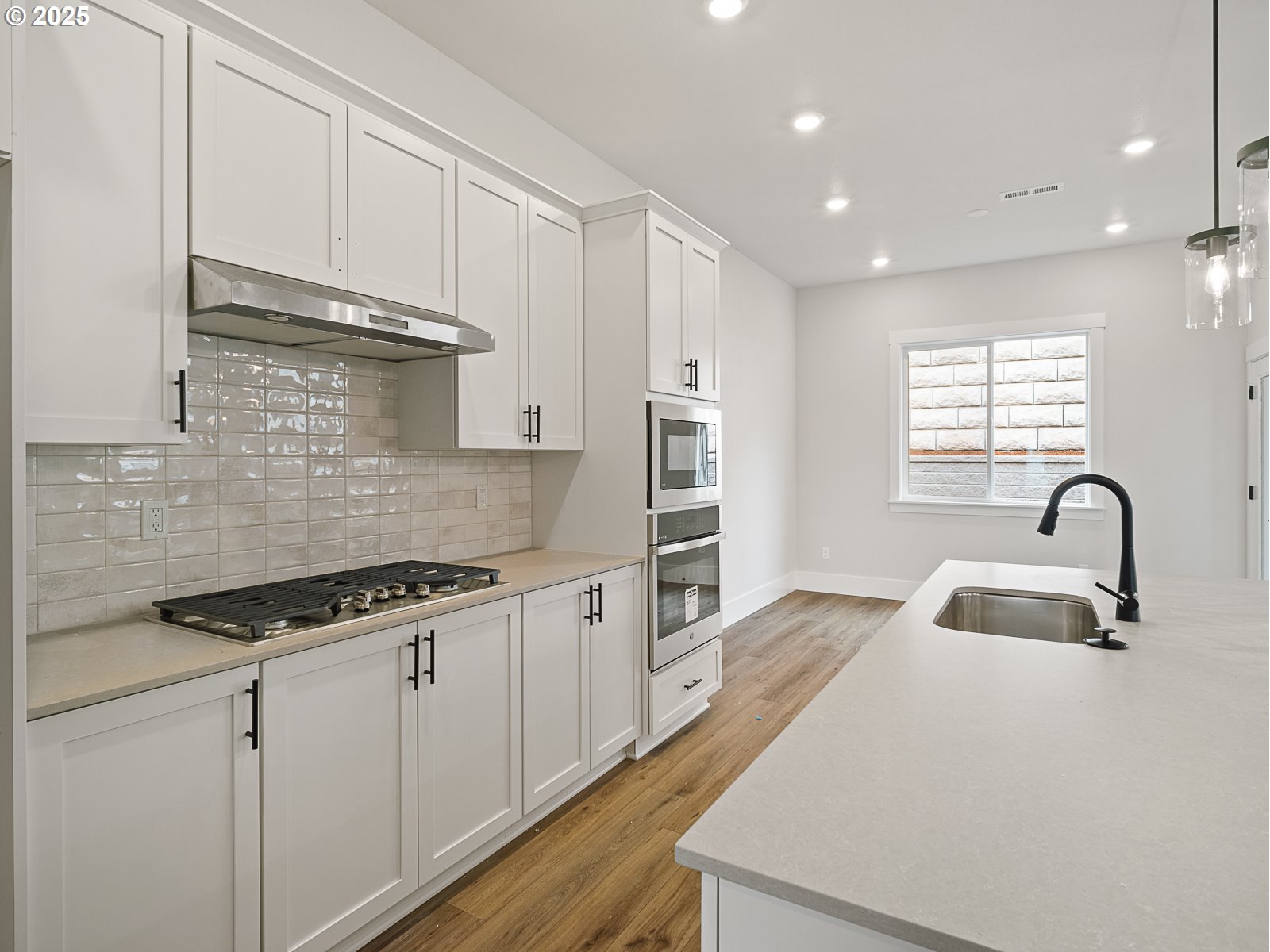 18045 Southwest Monashee Lane Beaverton, OR 97007 - Photo 17 of 45 a kitchen with granite countertop a sink stainless steel appliances and cabinets